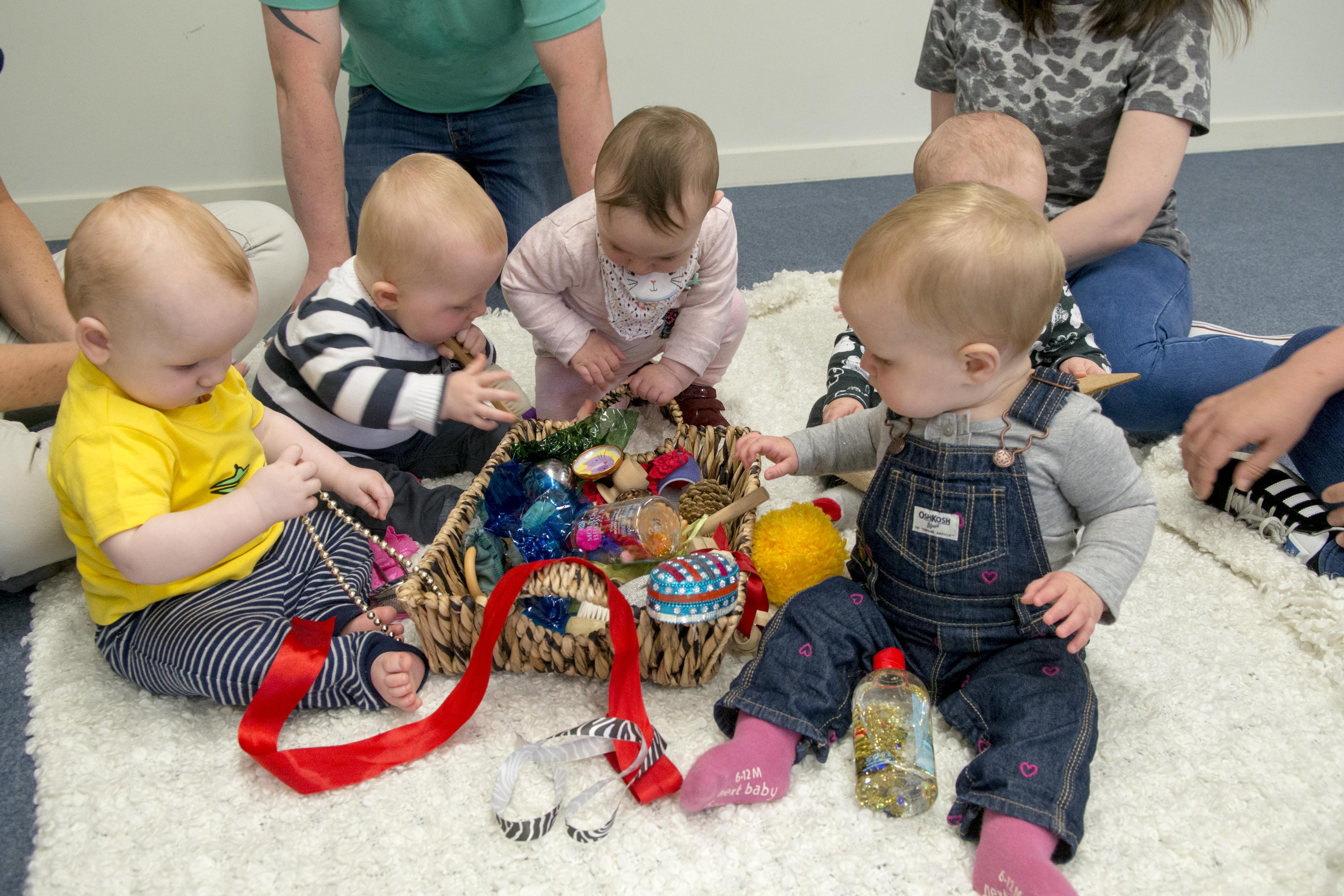 Babies playing with treasure basket