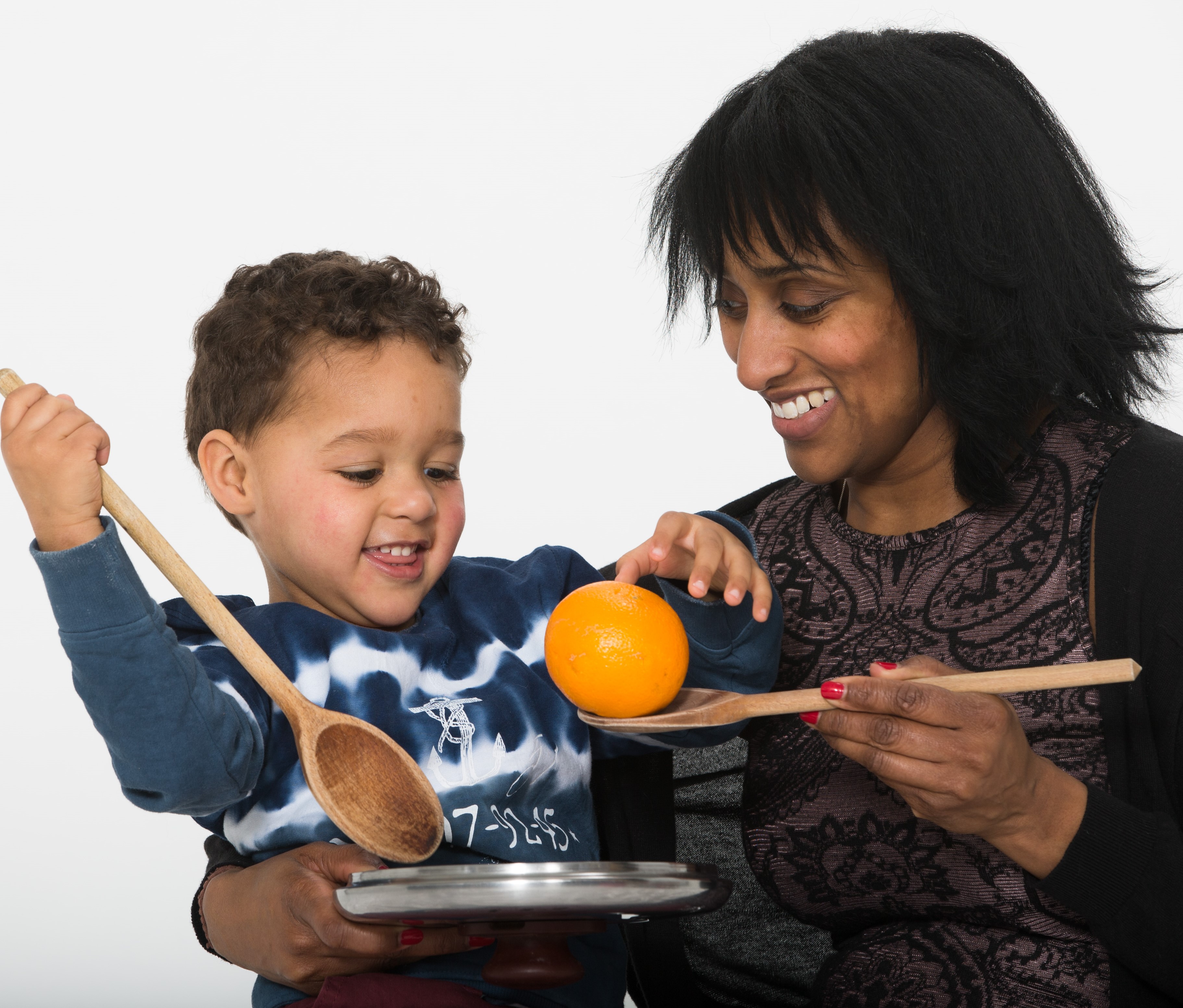 playing with orange and wooden spoon playing with orange and wooden spoon